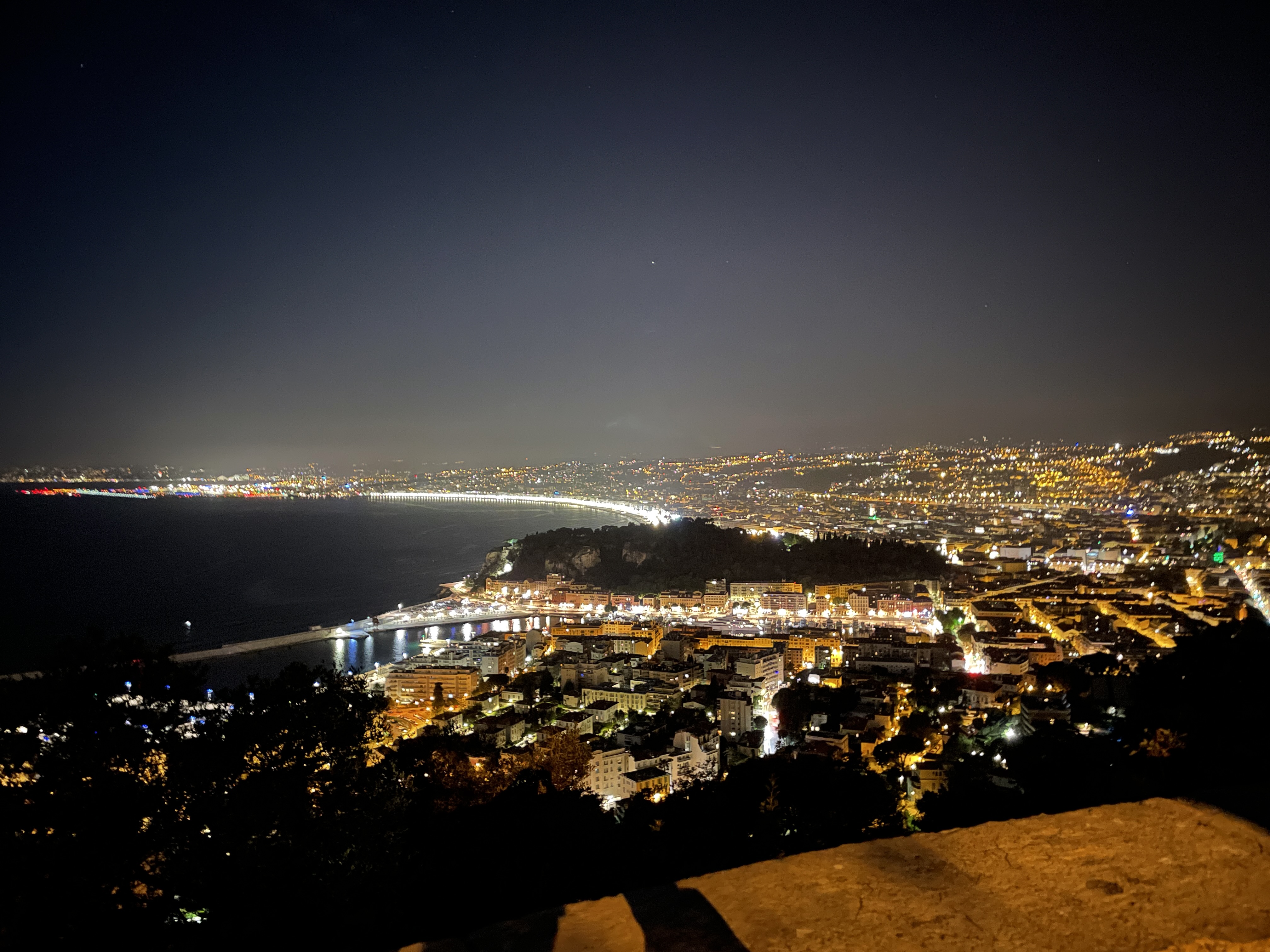 Monaco Formula 1 circuit illuminated with city lights reflecting on water