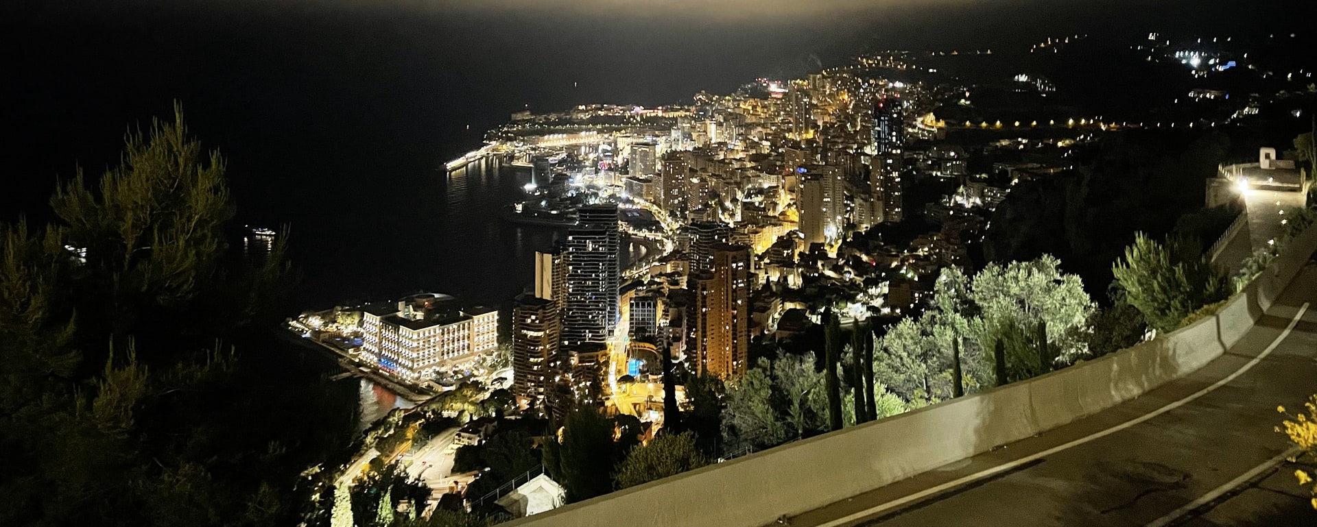 Monte Carlo city lights sparkling above the Mediterranean at night