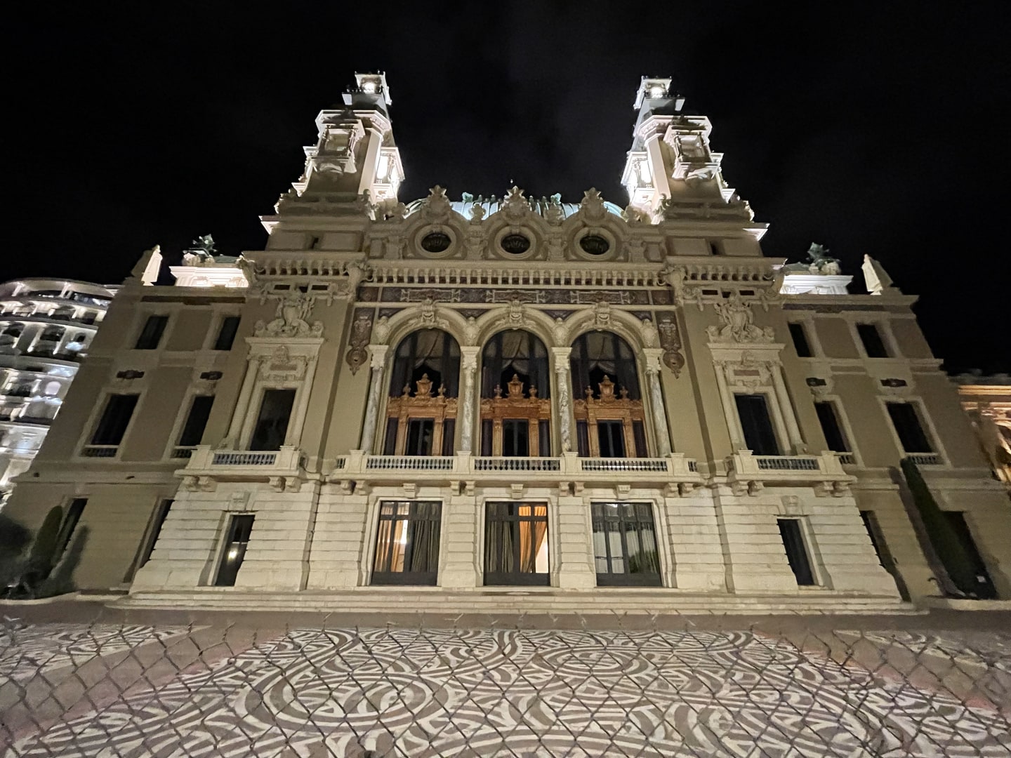 Monte Carlo Opera House glowing beneath the night sky